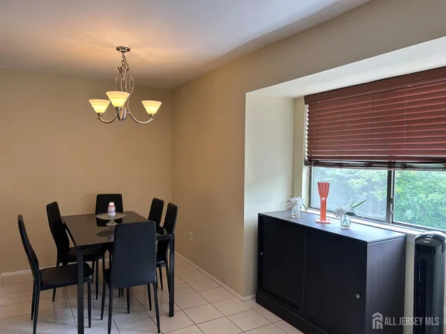 a dining room with furniture and a window