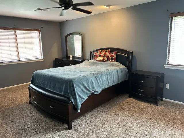 a bedroom with a bed and window