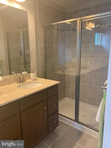 a bathroom with a shower and a sink