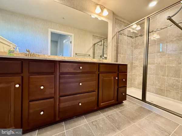 a bathroom with a sink vanity and mirror