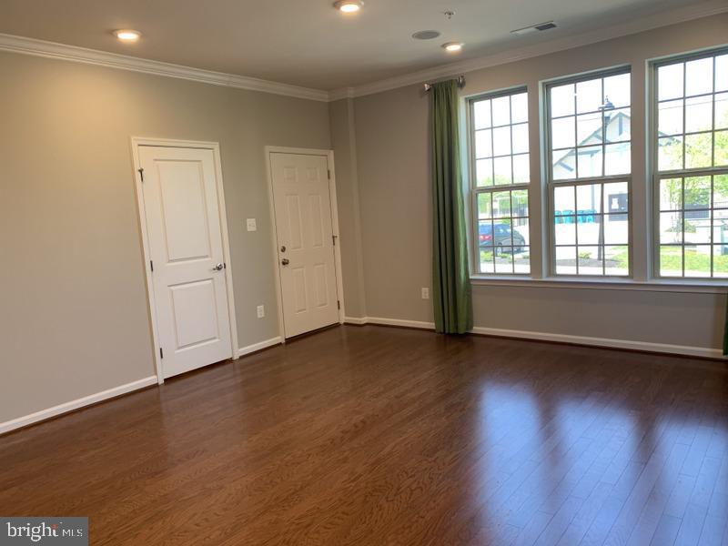 6491 Jack Linton Drive South Frederick, MD 21703 - Photo 7 of 24 an empty room with wooden floor and windows
