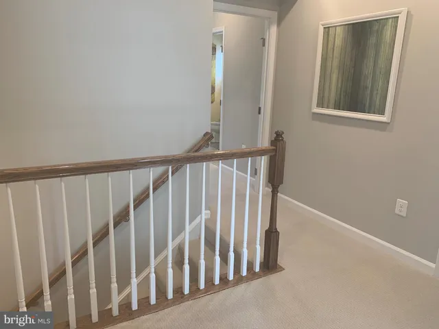 a view of staircase with rug