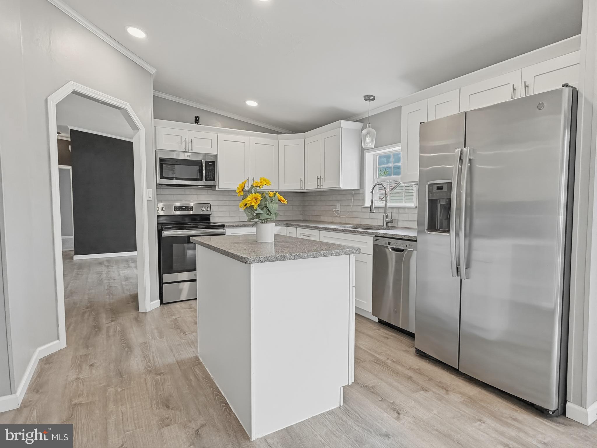 1137 2nd Avenue Croydon, PA 19021 - Photo 9 of 37 a kitchen with kitchen island a refrigerator and a stove top oven
