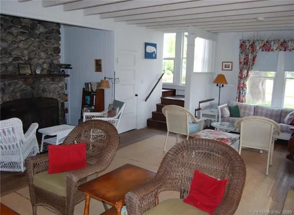 a dining room with furniture a mirror a lamp and window