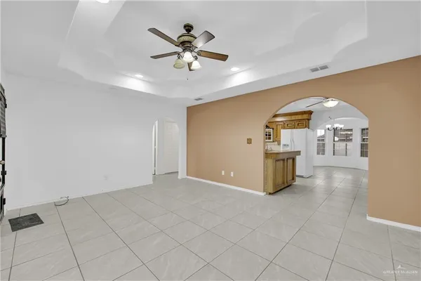 a view of a livingroom with a ceiling fan and wooden floor