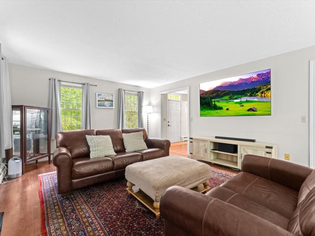 157 Harvard Road Bolton, MA 01740 - Photo 11 of 42 a living room with furniture a flat screen tv and a window