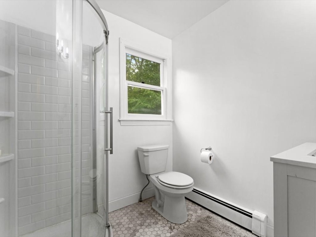 157 Harvard Road Bolton, MA 01740 - Photo 12 of 42 a white toilet sitting next to a bathroom sink
