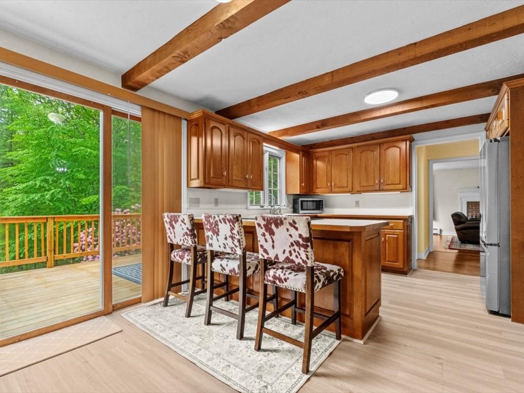 157 Harvard Road Bolton, MA 01740 - Photo 15 of 42 a view of a dining room with furniture window and wooden floor