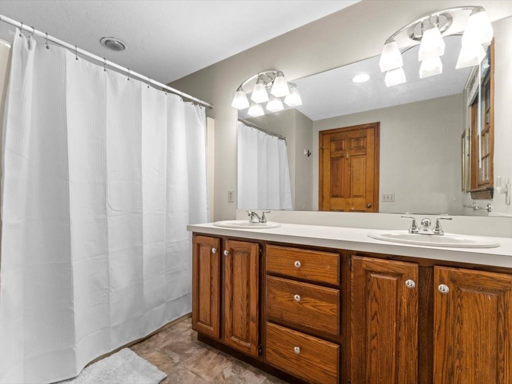157 Harvard Road Bolton, MA 01740 - Photo 25 of 42 a bathroom with a double vanity sink and a mirror