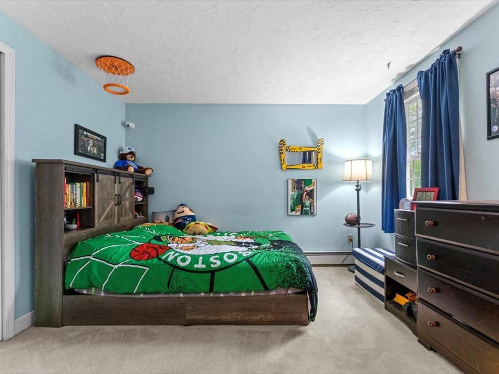 157 Harvard Road Bolton, MA 01740 - Photo 28 of 42 a room with toys and a wooden floor