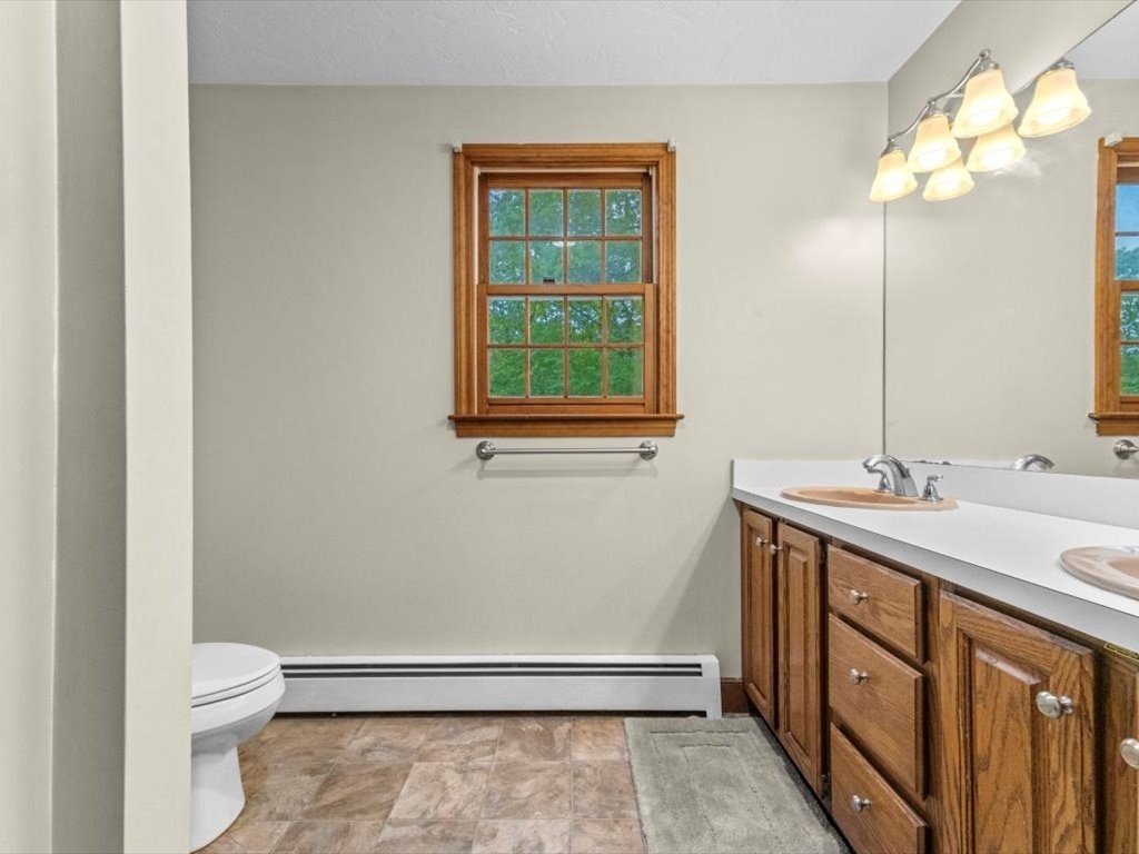 157 Harvard Road Bolton, MA 01740 - Photo 30 of 42 a bathroom with a sink a toilet and a mirror