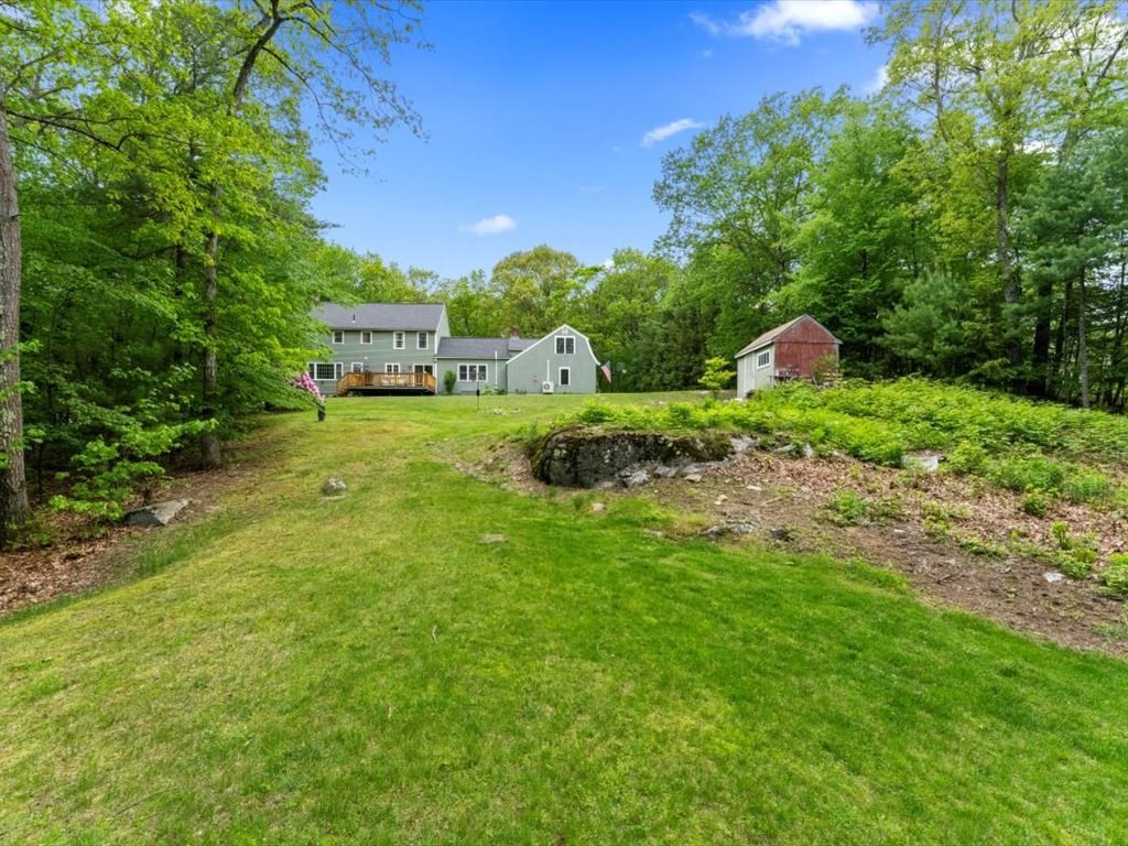 157 Harvard Road Bolton, MA 01740 - Photo 39 of 42 a front view of a house with a yard
