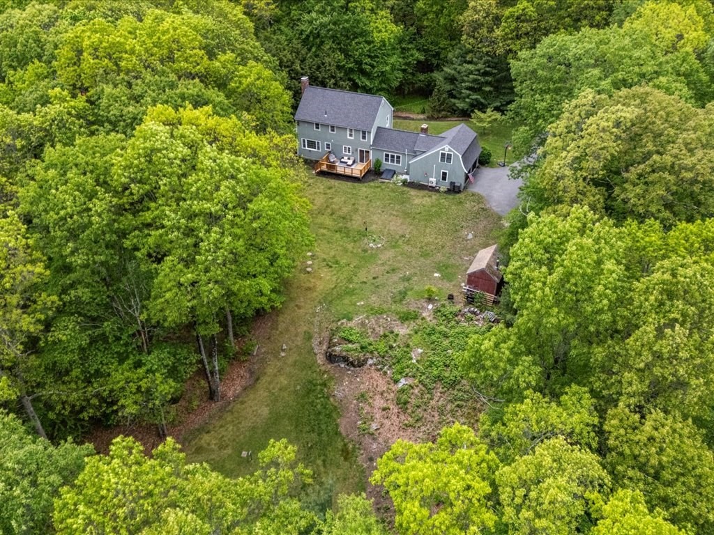 157 Harvard Road Bolton, MA 01740 - Photo 40 of 42 a view of a garden with a house