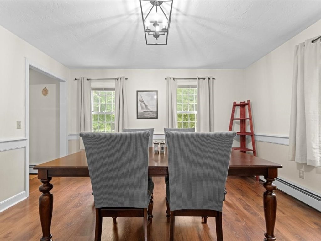 157 Harvard Road Bolton, MA 01740 - Photo 7 of 42 a view of a dining room with furniture and wooden floor