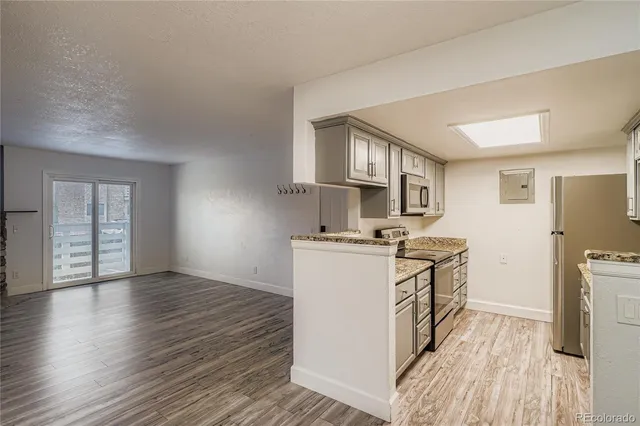 a kitchen with a stove a sink and a refrigerator
