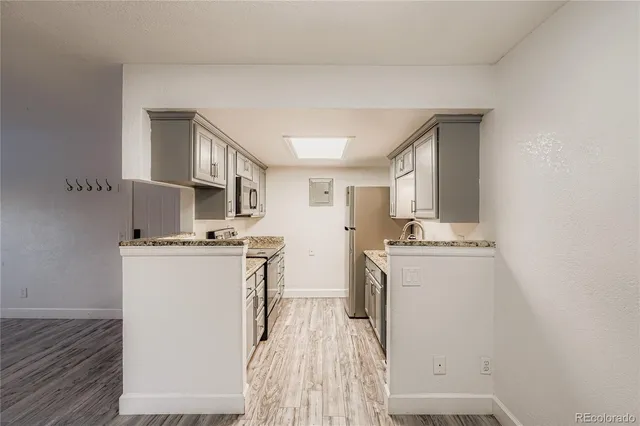 a kitchen with stainless steel appliances a stove refrigerator sink and cabinets