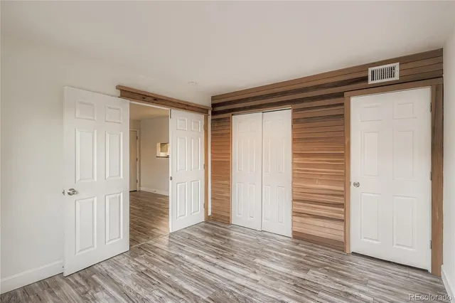 a view of empty room with wooden floor