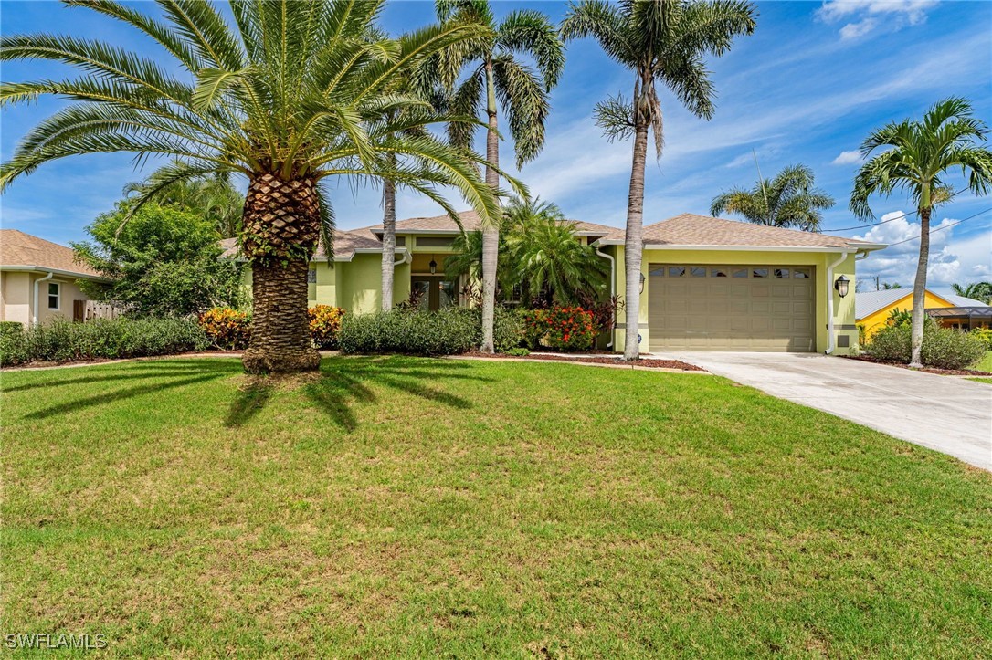 4513 Southwest 22nd Place Cape Coral, FL 33914 - Photo 1 of 38 a view of a house with a yard