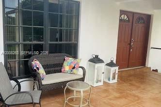a living room with furniture a rug and a window