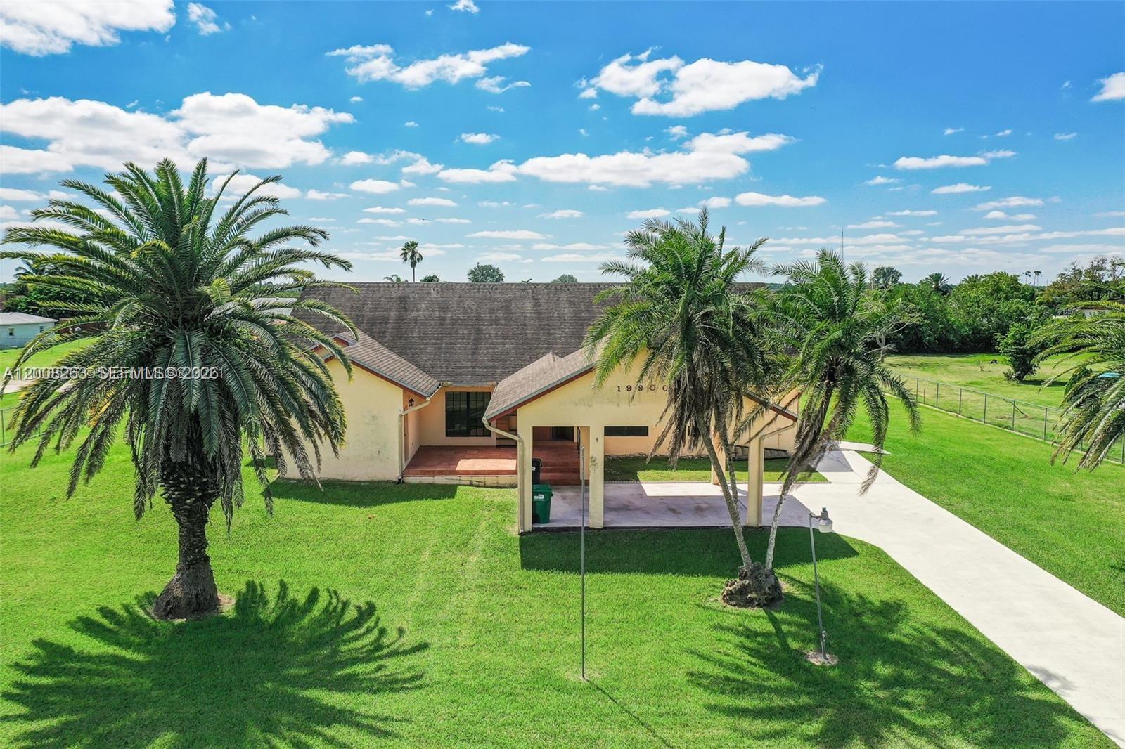 19900 Southwest 326th Street, Unit 1 Homestead, FL 33030 - Photo 11 of 11 a view of a house with a swimming pool