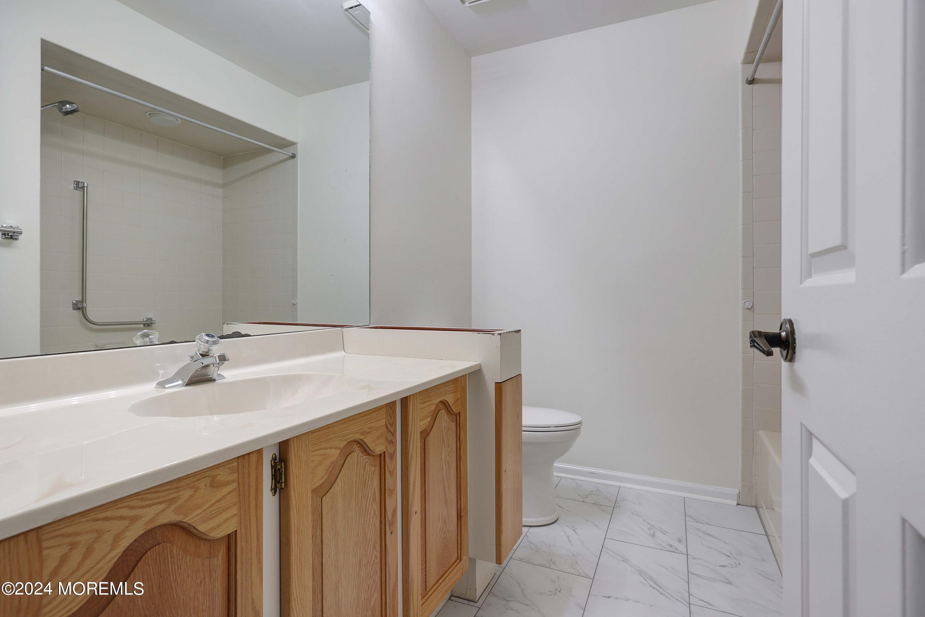 98 Greenbriar Boulevard Brick, NJ 08724 - Photo 23 of 31 a bathroom with a sink and a mirror