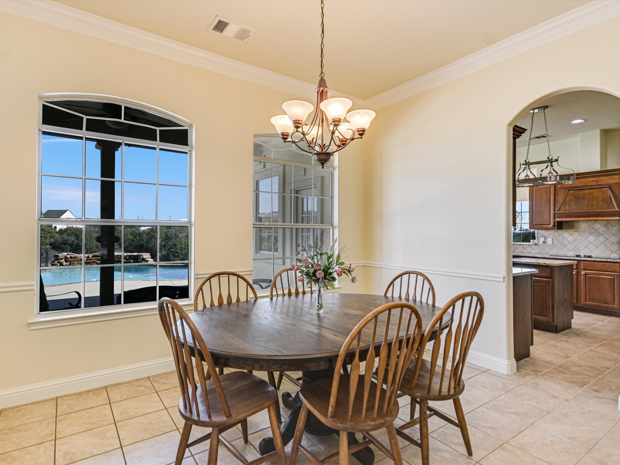 10111 Baxter Lane Austin, TX 78736 - Photo 15 of 35 a view of a dining room with furniture and chandelier