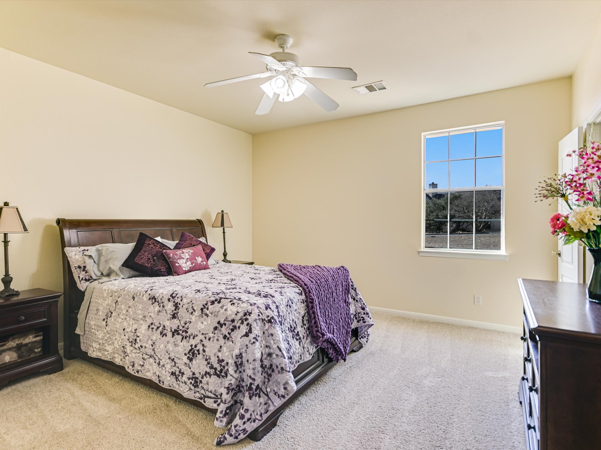 10111 Baxter Lane Austin, TX 78736 - Photo 23 of 35 a bedroom with a bed and a potted plant