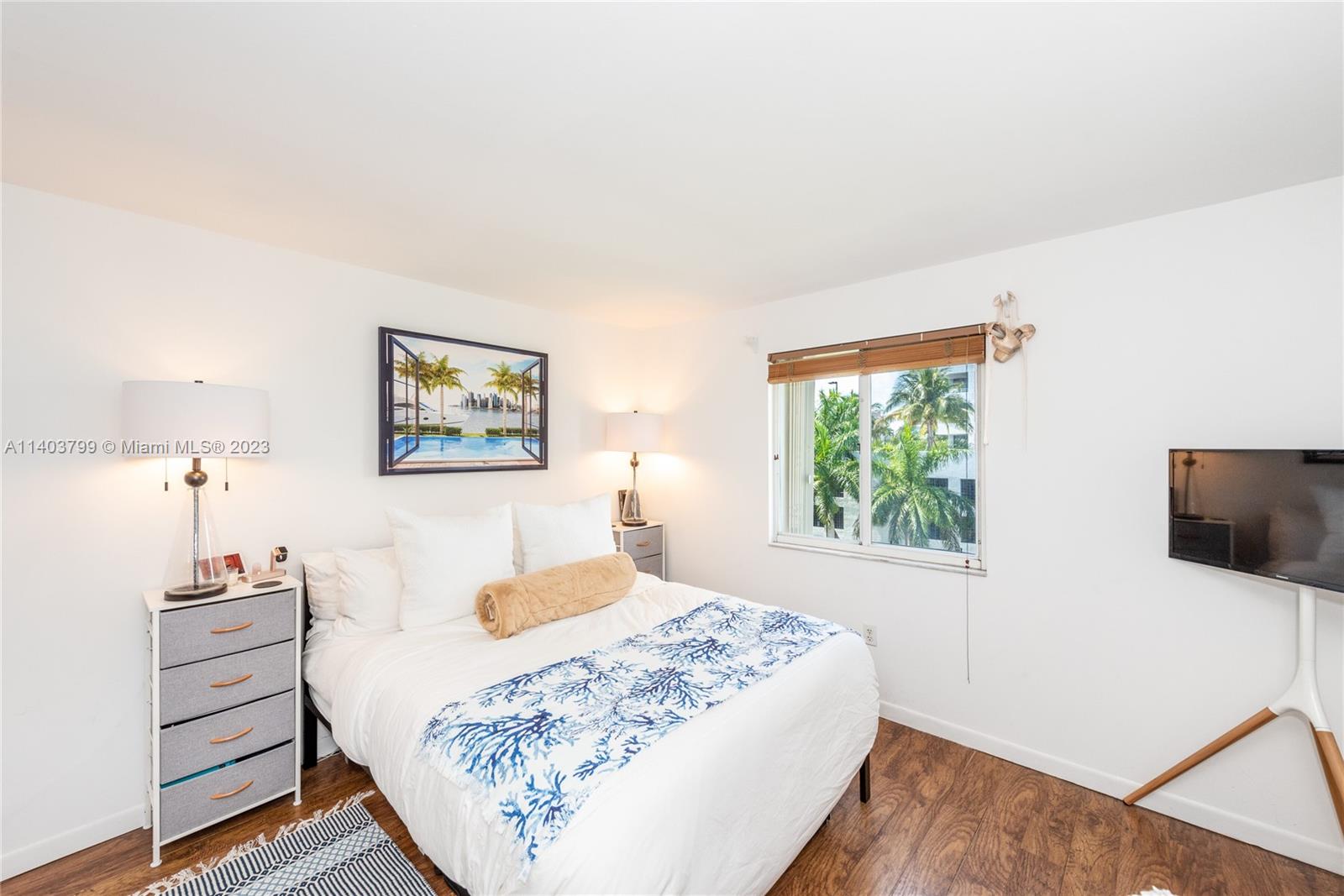 1401 Bay Road, Unit 503 Miami Beach, FL 33139 - Photo 13 of 18 a bedroom with a bed and a flat screen tv