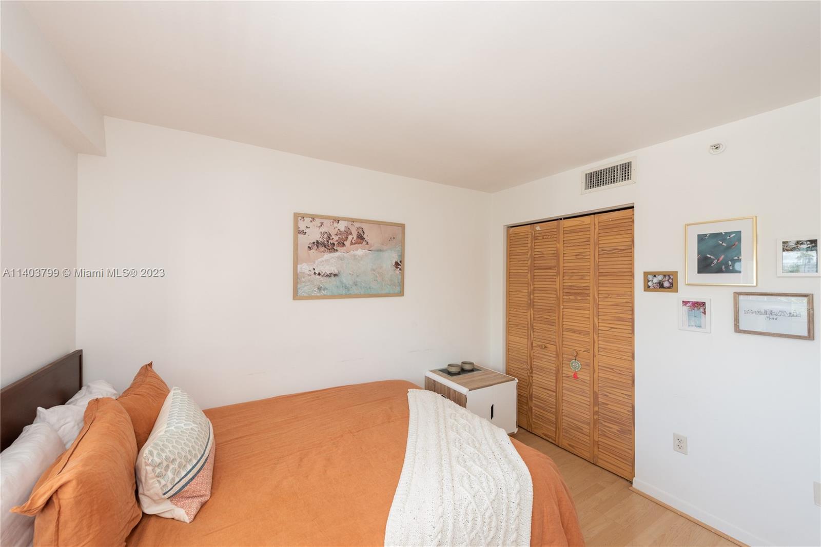 1401 Bay Road, Unit 503 Miami Beach, FL 33139 - Photo 16 of 18 a bedroom with a bed and a wall painting