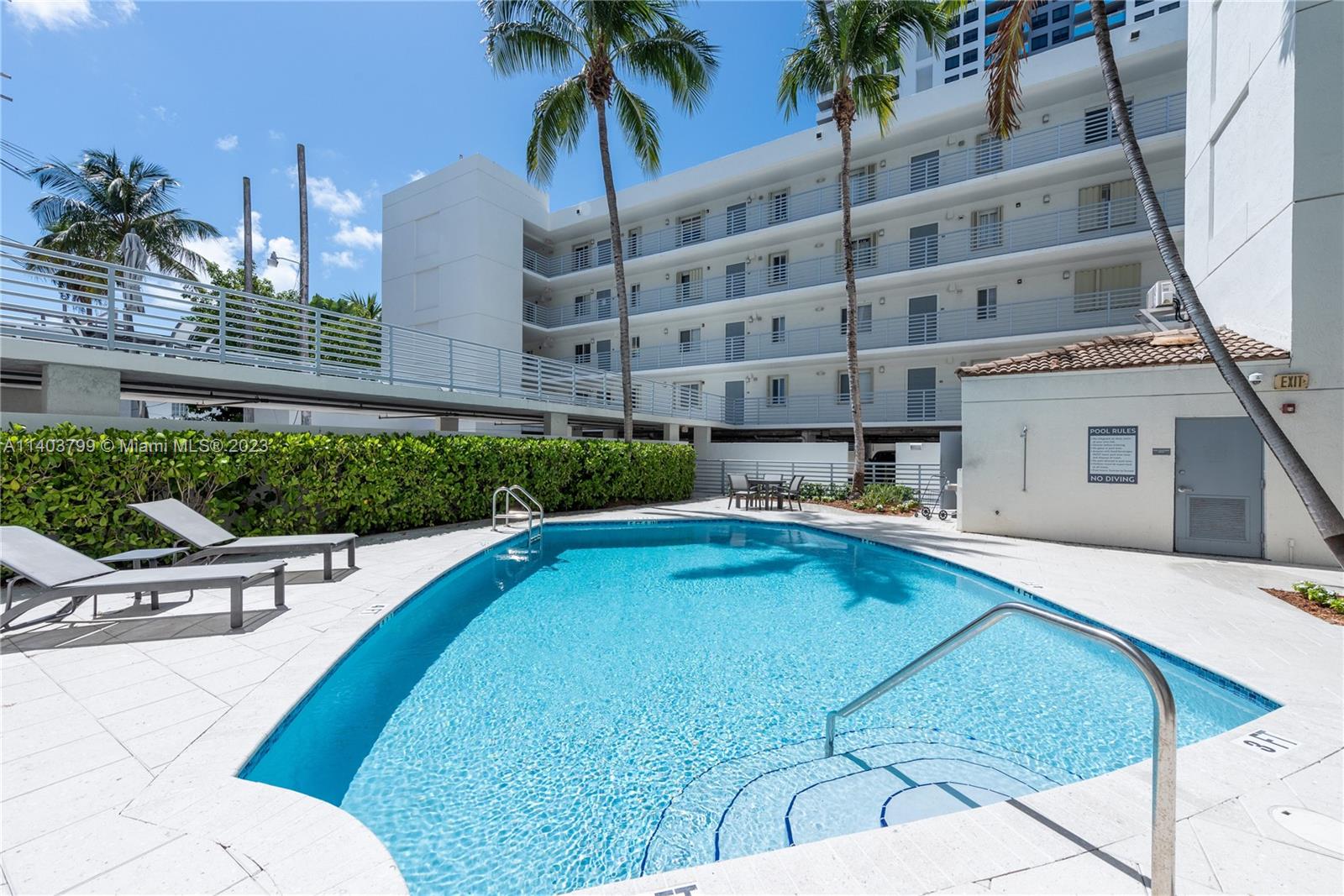 1401 Bay Road, Unit 503 Miami Beach, FL 33139 - Photo 18 of 18 a swimming pool with outdoor seating and yard