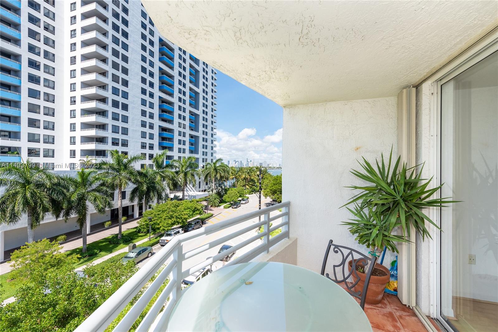 1401 Bay Road, Unit 503 Miami Beach, FL 33139 - Photo 2 of 18 a view of a balcony with potted plants and palm trees