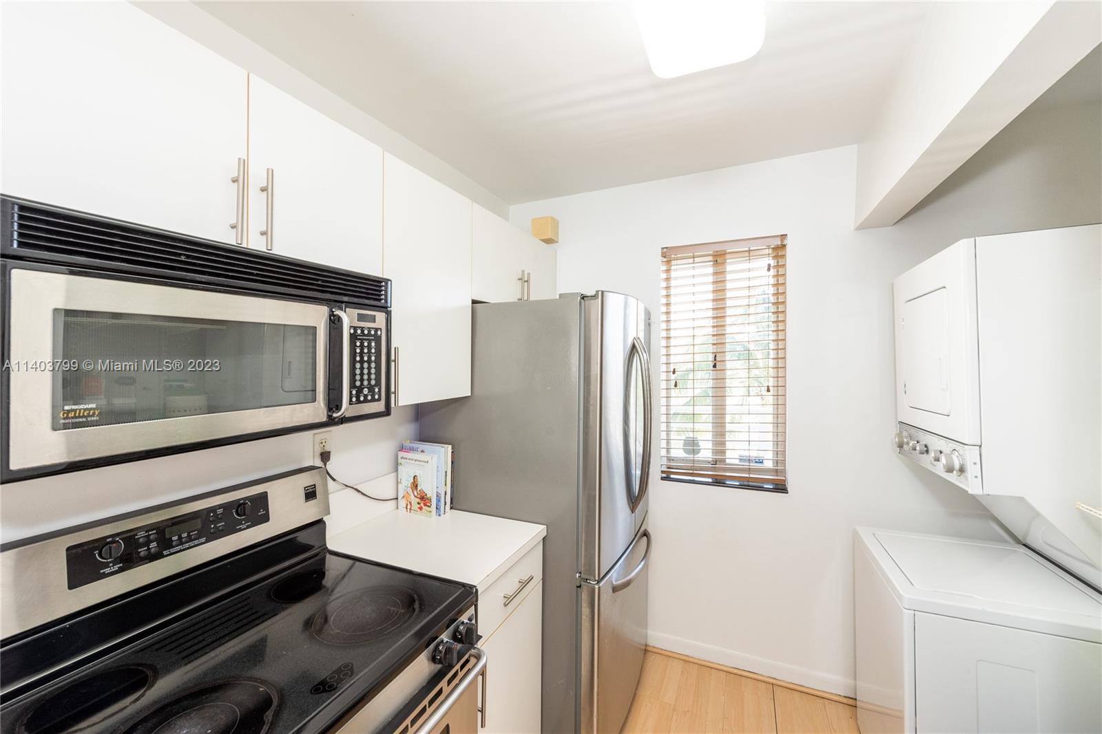 1401 Bay Road, Unit 503 Miami Beach, FL 33139 - Photo 10 of 18 a kitchen with a stove and a microwave