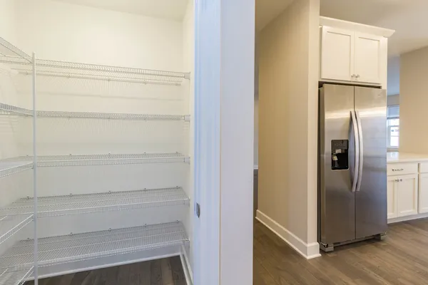 a view of walk in closet with empty racks