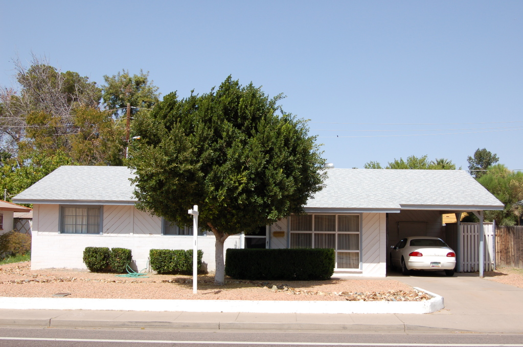 a view of house with outdoor space and parking