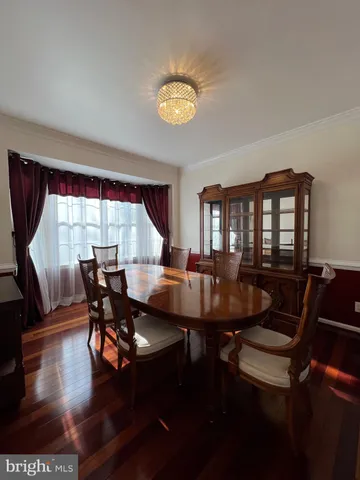 a view of a dining room with furniture and a window