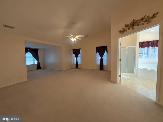 a view of a livingroom with furniture and a ceiling fan