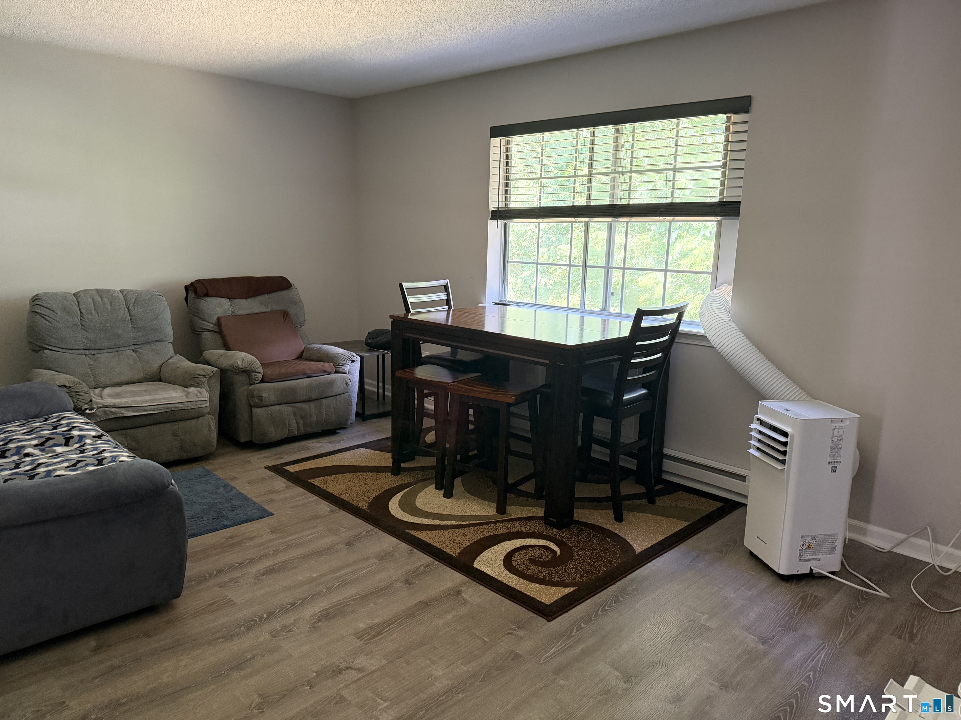 21 Lisa Court, Unit 10 Waterbury, CT 06704 - Photo 5 of 14 a living room with furniture a lamp and a window