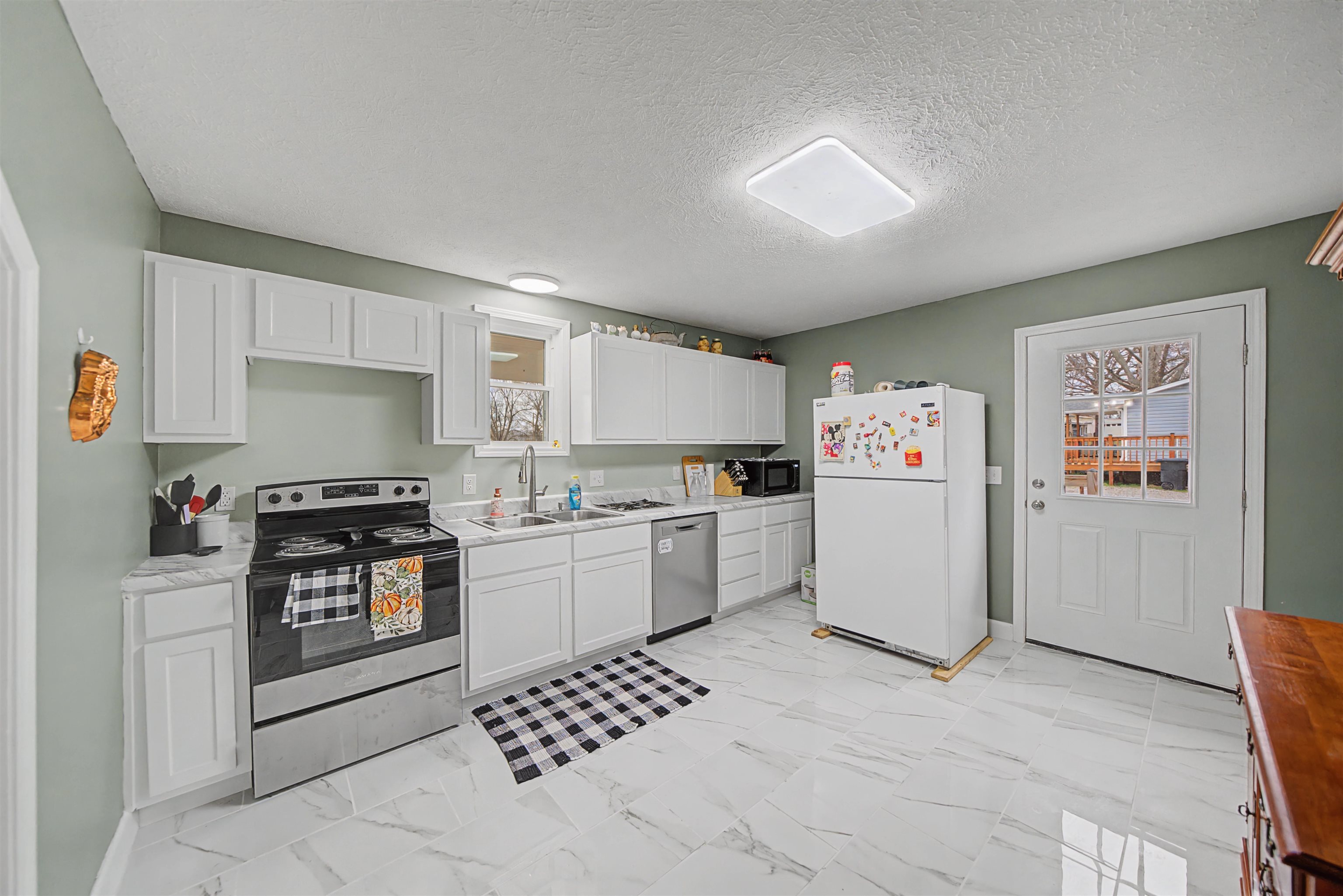 8040 45th Highway South Ramer, TN 38367 - Photo 12 of 20 a kitchen with a cabinets and white appliances