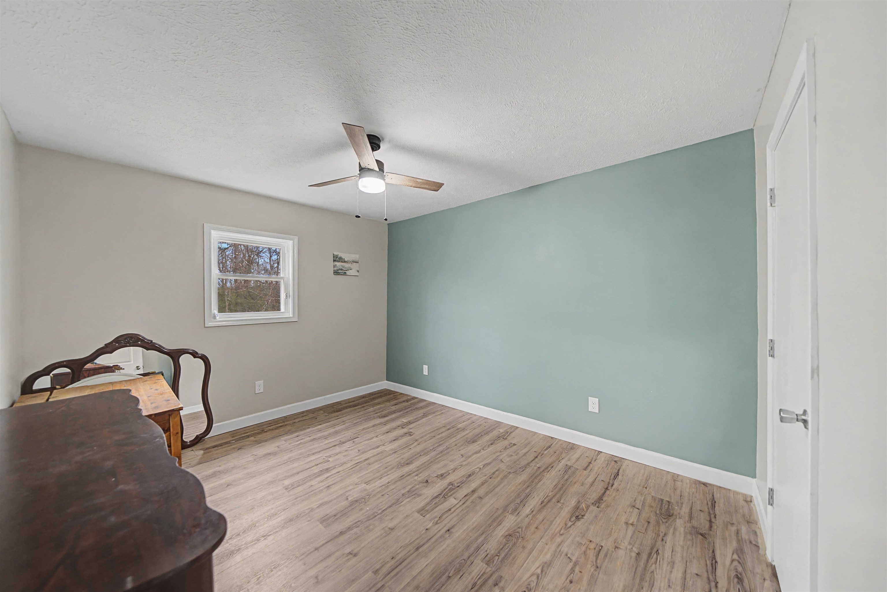 8040 45th Highway South Ramer, TN 38367 - Photo 17 of 20 a view of a room with wooden floor and ceiling fan