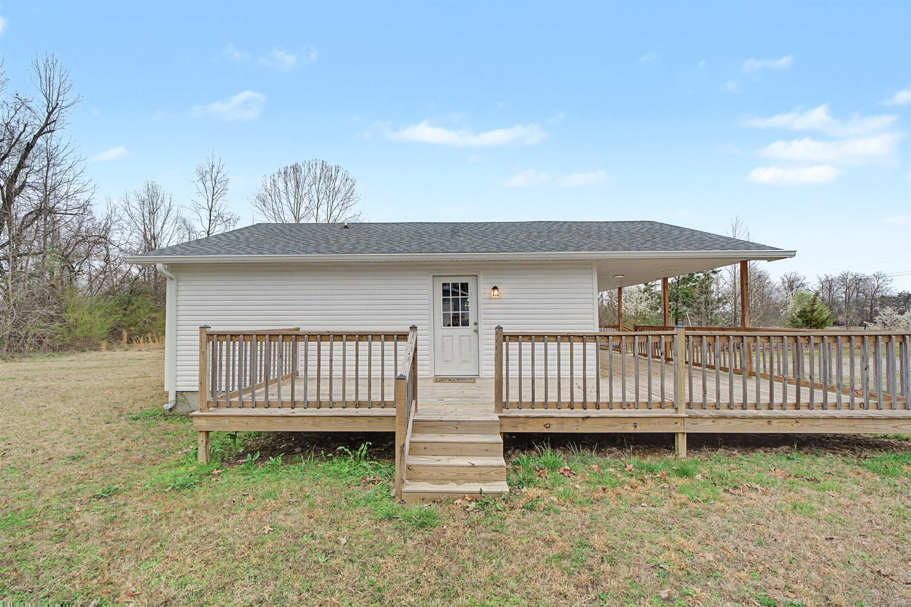8040 45th Highway South Ramer, TN 38367 - Photo 4 of 20 a view of a yard with wooden fence and a floor to ceiling window