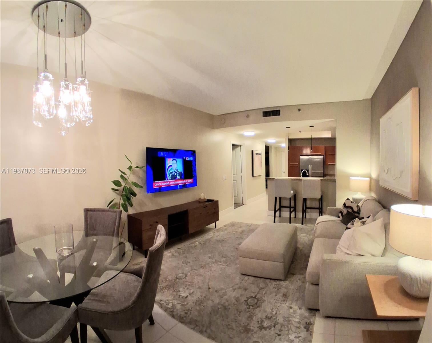 2641 North Flamingo Road, Unit 2607N Sunrise, FL 33323 - Photo 18 of 69 a living room with furniture and a chandelier
