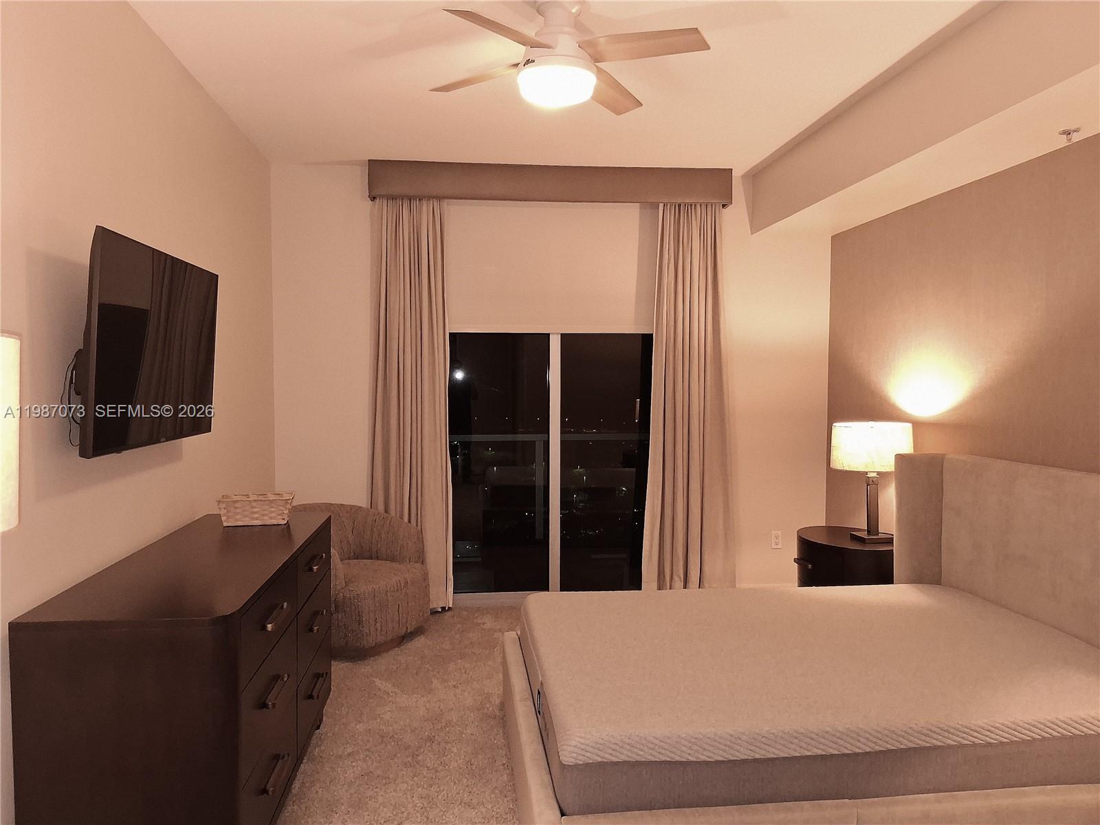 2641 North Flamingo Road, Unit 2607N Sunrise, FL 33323 - Photo 27 of 69 a bedroom with a bed and a flat tv screen on dresser