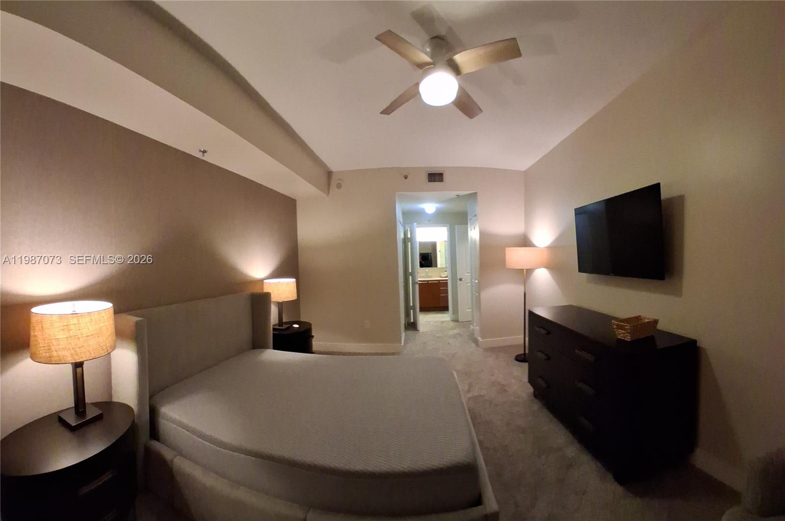 2641 North Flamingo Road, Unit 2607N Sunrise, FL 33323 - Photo 29 of 69 a bedroom with a bed and a flat screen tv