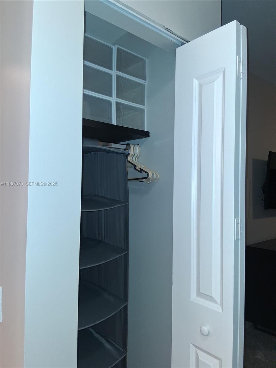 2641 North Flamingo Road, Unit 2607N Sunrise, FL 33323 - Photo 38 of 69 a view of walk in closet with empty racks