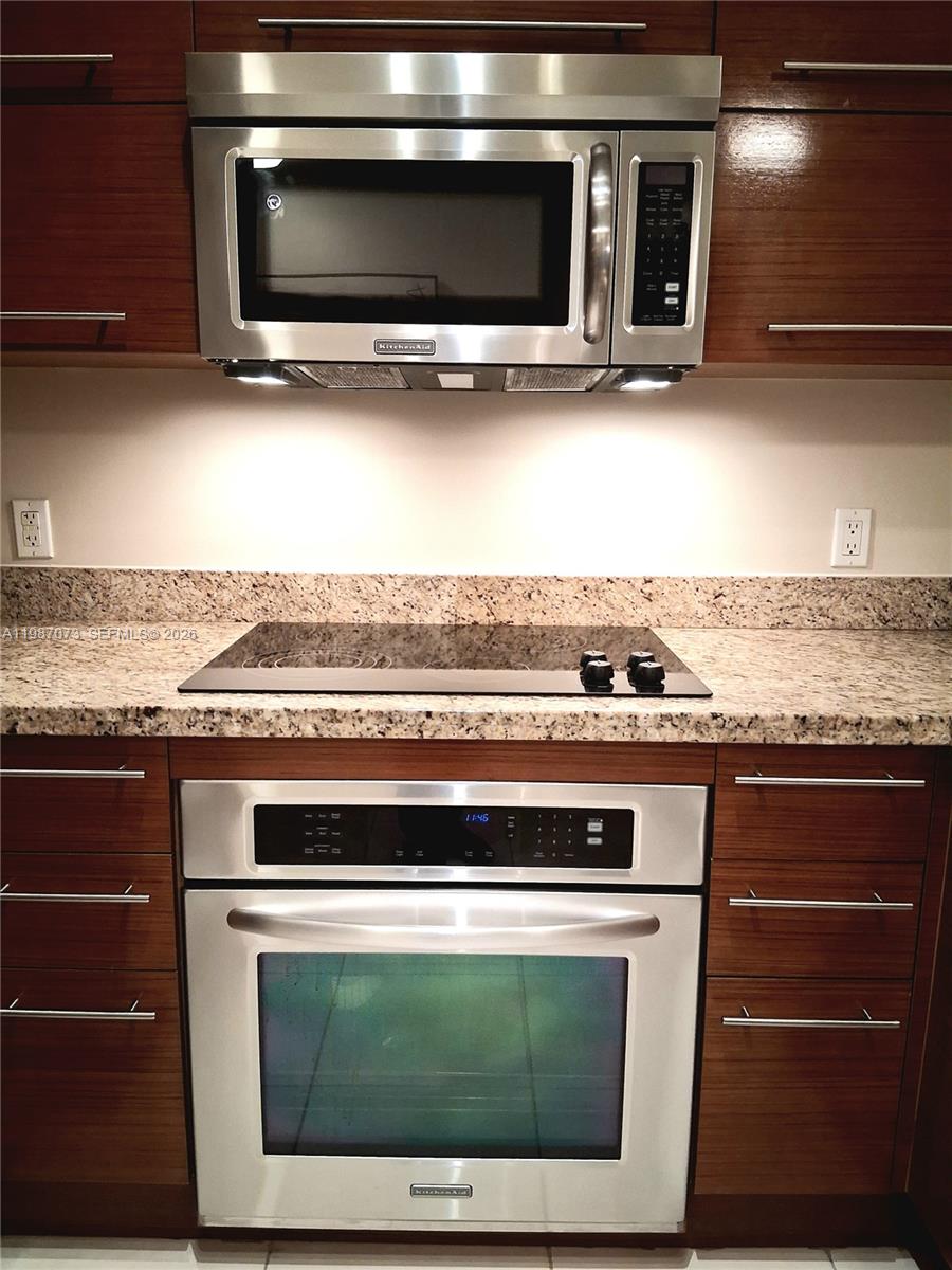 2641 North Flamingo Road, Unit 2607N Sunrise, FL 33323 - Photo 5 of 69 a stove top oven sitting inside of a kitchen