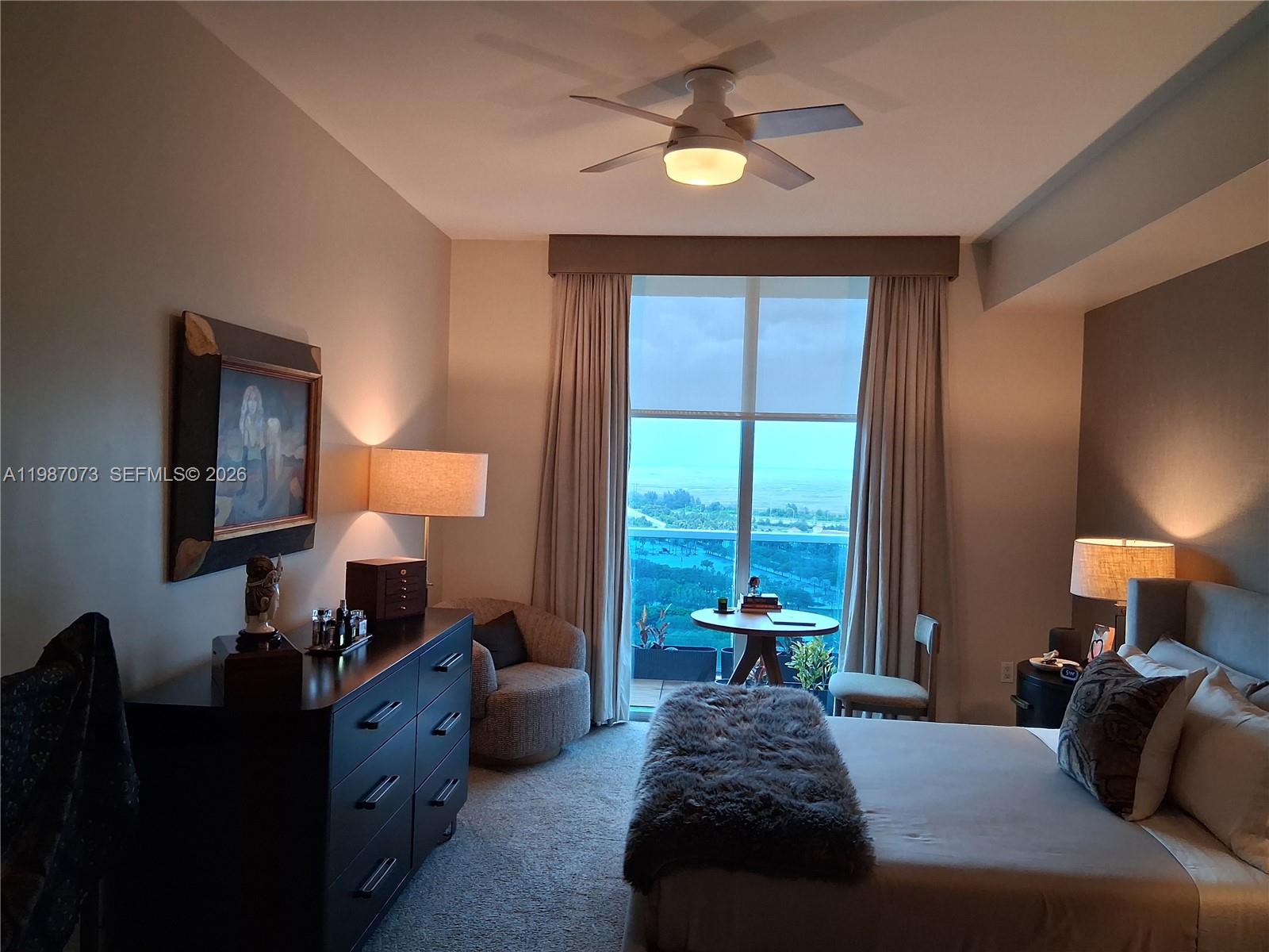 2641 North Flamingo Road, Unit 2607N Sunrise, FL 33323 - Photo 51 of 69 a bedroom with a bed and a lamp on dresser