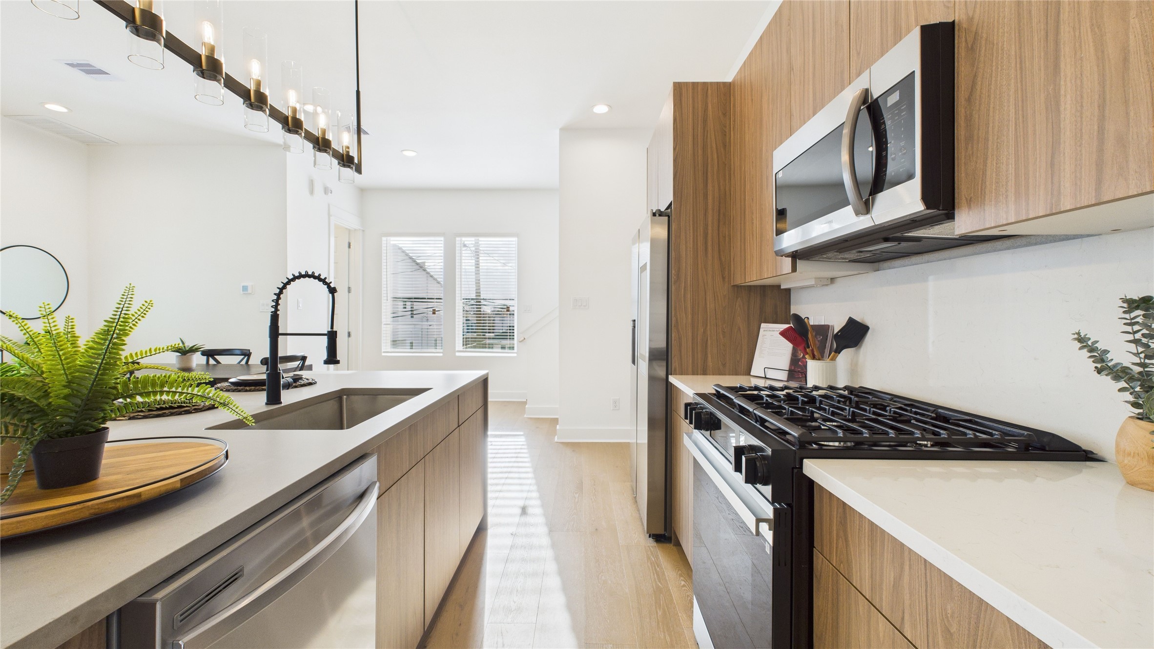 2428 Freeman Street Houston, TX 77009 - Photo 21 of 46 The kitchen is equipped with sleek, modern cabinets, offering ample storage while maintaining a clean, contemporary look; perfect for keeping everything organized and stylish in the heart of the open concept living space.
