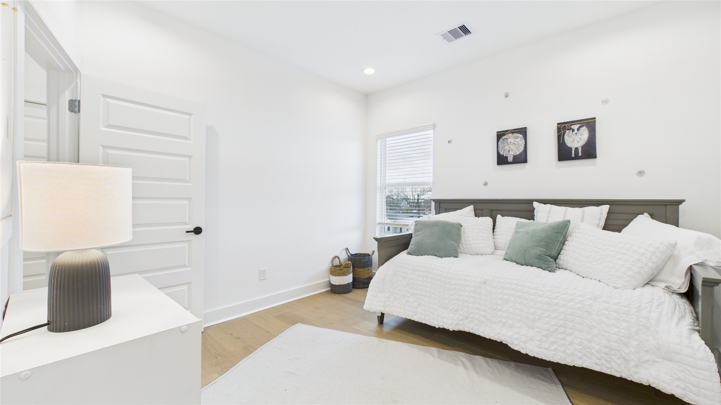 2428 Freeman Street Houston, TX 77009 - Photo 34 of 46 The second secondary bedroom on the third floor offers ample space and includes a private ensuite full bathroom, providing comfort and privacy in a well-appointed setting.