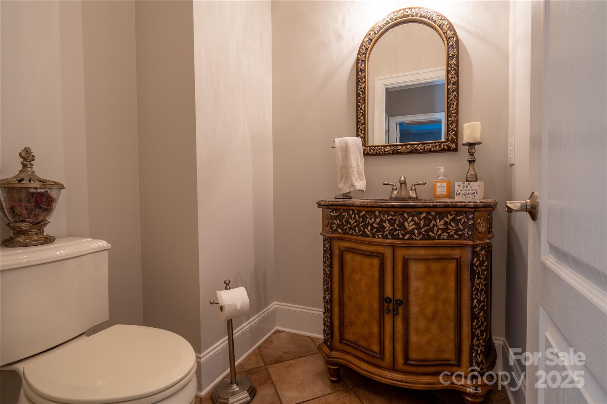 1427 Merrimont Avenue Kings Mountain, NC 28086 - Photo 22 of 48 a bathroom with a toilet a sink and mirror