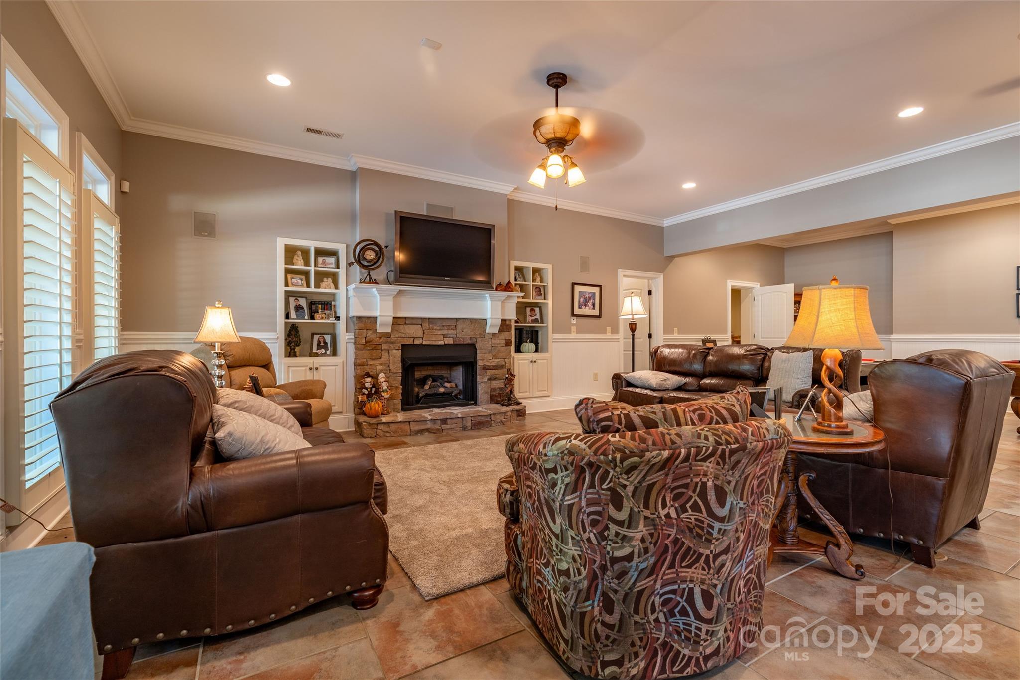 1427 Merrimont Avenue Kings Mountain, NC 28086 - Photo 35 of 48 a living room with furniture a fireplace and a flat screen tv